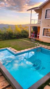 a swimming pool in the backyard of a house at Riyansh Villa 5 bhk with Swimming Pool in Panchgani