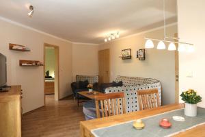 a living room with a table and a dining room at Ferienwohnung Sonnenhang-Hartmann in Olsberg