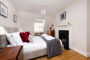 a bedroom with a large bed and a fireplace at 2 bed Haywood Cottage with garden in Stenton