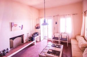 a living room with a couch and a fire place at Als Marmarei in Ioulis