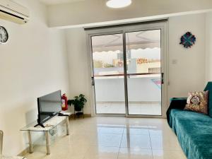 a living room with a couch and a tv at Cyprus Penelope in Larnaka