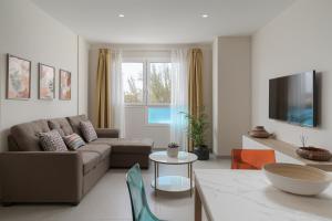a living room with a couch and a table at Las Afortunadas - Playa Arinaga 2ºC in Arinaga