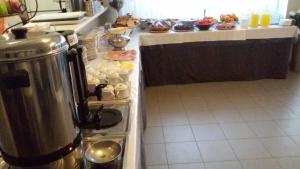 a kitchen with a counter with a buffet of food at Danaos Hotel in Chania