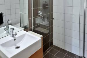 a bathroom with a sink and a shower at City Centre Apt - 3 Bed/Parking/CBD/WiFi in Adelaide
