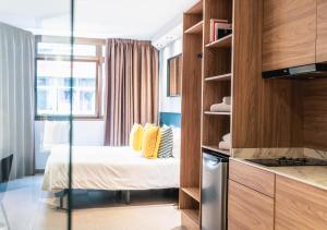A bed or beds in a room at Poem Apartments, Las Canteras