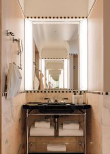 a bathroom with a sink and a large mirror at Sommerro in Oslo