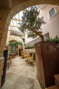 a restaurant with a tree in the middle of a patio at The Heritage Boutique Accommodation in Rabat