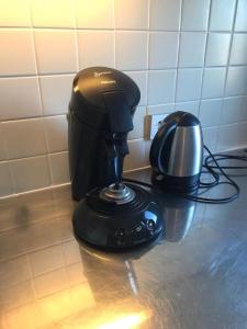 a coffee maker and a telephone on a counter at Studio Le Sandettie à 50m de la plage! in Fort-Mahon-Plage