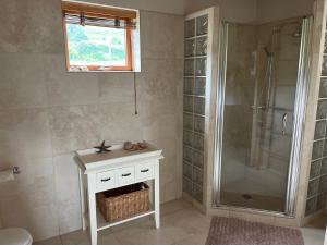 a bathroom with a shower and a sink and a toilet at Helgafell retreat center in Akureyri