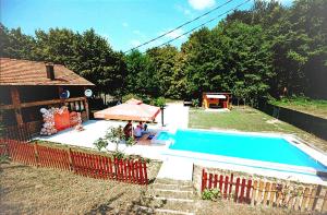 a swimming pool in a yard next to a house at Villa FORESTA in Banja Luka +25 photos