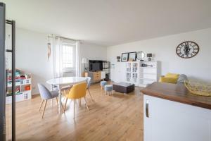 a kitchen and living room with a table and chairs at Superb family duplex clos to Disneyland in Bussy-Saint-Georges