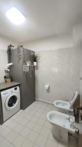 a bathroom with a washing machine and a toilet at Il ponticello in Ortona +29 photos