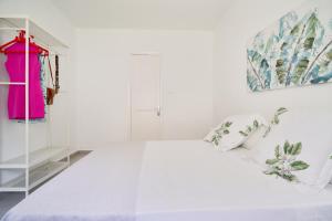 um quarto branco com uma cama branca e uma prateleira em Villa Rosita Suites en Playa de la Malagueta con terraza em Málaga