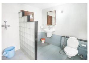 a bathroom with a toilet and a sink at Magnolia Villa 4 BHK in Jaipur