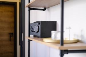 a microwave sitting on a shelf in a room at Alex & Rine - Pension Zum Alten Strom in Warnemünde