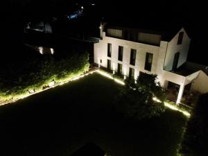 an aerial view of a house at night with lights at Nature & Sea - Casa Vinhateira East Duplex in Caloura