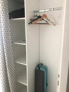 um closet com uma prateleira e uma mala em Chambre d’hôte Chancelier Guerin em Mont-lʼEvêque