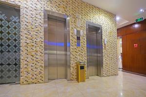 a elevator lobby with two elevators in a building at EKONO by Leva Jeddah Airport Hotel in Jeddah