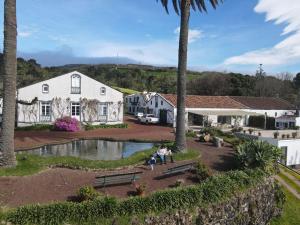 a group of people standing in front of a house at Nature & Sea - Casa da Vinhateira South in Caloura