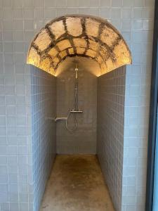 a bathroom with a shower in a tiled room at Nature & Sea - Casa da Vinhateira South in Caloura