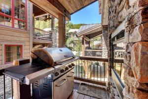 a outdoor kitchen with a grill on a balcony at Ski In Out Luxury Villa #492 With Hot Tub & Great Views - 500 Dollars Of FREE Activities & Equipment Rentals Daily in Winter Park