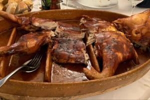 a bowl of food with meat and a fork on a table at Casa Enrique Soria in Santervás de la Sierra