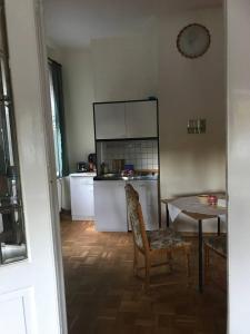 a kitchen with a table and a table and a chair at Ferienwohnung in Villa in Bad Elster