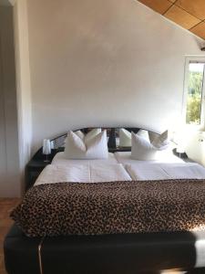 a bedroom with two beds with white pillows and a window at Ferienwohnung in Villa in Bad Elster