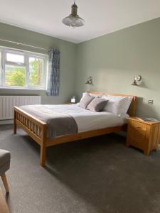 Un dormitorio con una cama grande y una ventana en Marshpools Bed & Breakfast - Licensed near Weobley village, en Weobley