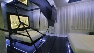 a bedroom with a bed and a window with a city at C rooms - Love Motel Monza in Cinisello Balsamo