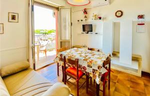 a living room with a table and a balcony at San Remo in Lido di Pomposa
