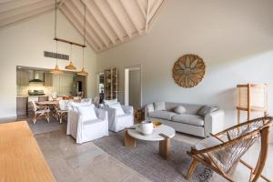 a living room with white furniture and a table at Newly Added El Portillo 2BR Apt in Abra Grande