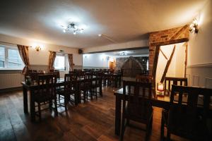 a dining room filled with wooden tables and chairs at The Lamb of Rhos in Llandysul