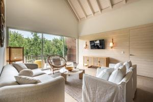 a living room with white furniture and a large window at Newly Added El Portillo 2BR Apt in Abra Grande