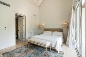 a white bedroom with a bed and a rug at Newly Added El Portillo 2BR Apt in Abra Grande +23 photos