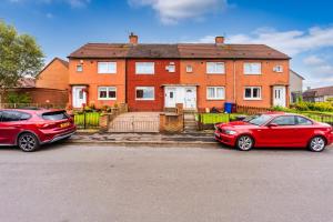 two red cars parked in front of a house at Scotia House -3 bed house in Larkhall with private driveway in Larkhall