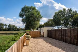 a wooden fence with a gate and a fence sidx sidxktopktop at Finest Retreats - Rosebud Cottage in Wedmore