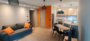 a living room with a couch and a table and a kitchen at Casa Vacanza Beltrami in Baceno