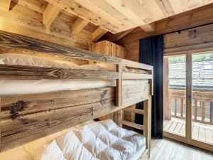 two bunk beds in a room with a wooden wall at Polaris 1 003 - LUXE & SKI LIFT apartment 6 pers in Zinal
