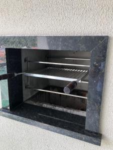 a metal grill with a roll at Itacolomi Home Club Apto 404 T1 in Penha