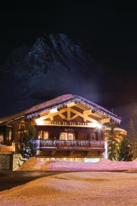 a building with a mountain in the background at Chalet Hotel L’Ecrin in Tignes