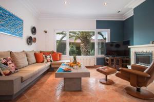 a living room with a couch and a tv at Villa Yoko - Plusholidays in Calpe