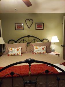 a bedroom with a bed with a heart on the wall at Applinger Farm in Ashland