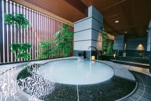 a pool of water in the middle of a building at Sora Niwa Terrace Kyoto in Kyoto
