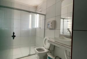 uma casa de banho branca com um WC e um lavatório em HOTEL UNA em Palmares