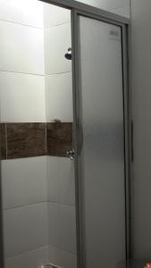 a shower with a glass door in a bathroom at Hotel El Coliseo in Manizales