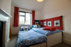 a bedroom with two beds and a window at Blachington Cottage, Stunning and Central By Air Premier in Seaford