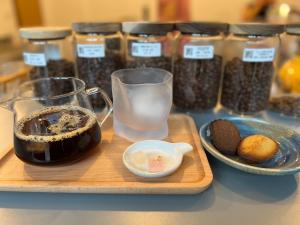 a tray with jars of seeds and a plate of cookies at 味知旅宿 Unknown house in Xiaoliuqiu