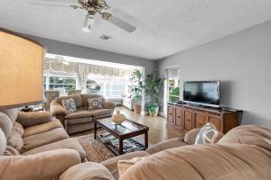 a living room with couches and a flat screen tv at 232 S HARBOR DR - ISLAND BAY home in Holmes Beach