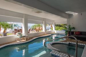 a large swimming pool in a house with a swimming poolvisor at 232 S HARBOR DR - ISLAND BAY home in Holmes Beach